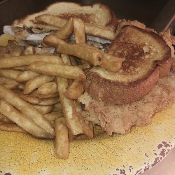 Southern Taste Cafe's fried chicken sandwich on Texas toast with a side of golden french fries.